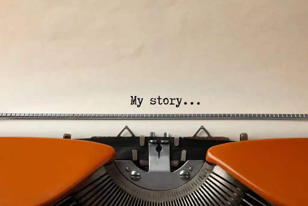 Typewriter with the words "My story..." on paper, symbolizing personal narrative and storytelling.