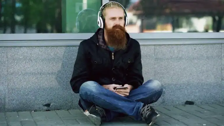 Man wearing headphones sitting in quiet solitude outdoors