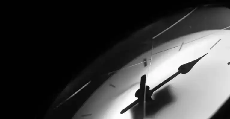 Close-up of a clock face, evoking the distorted sense of time that trauma creates